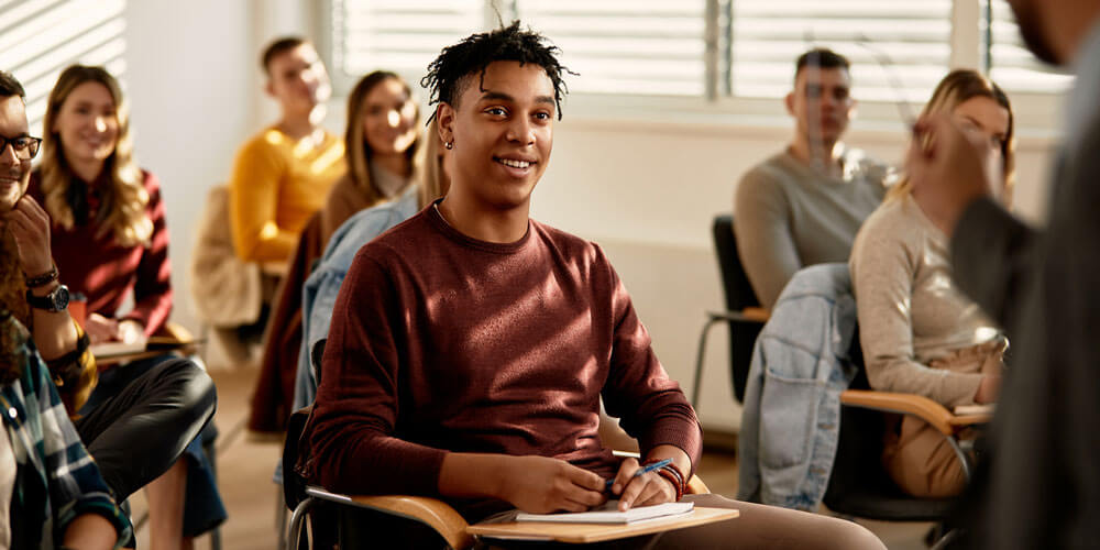 Class of students, focused on one smiling student