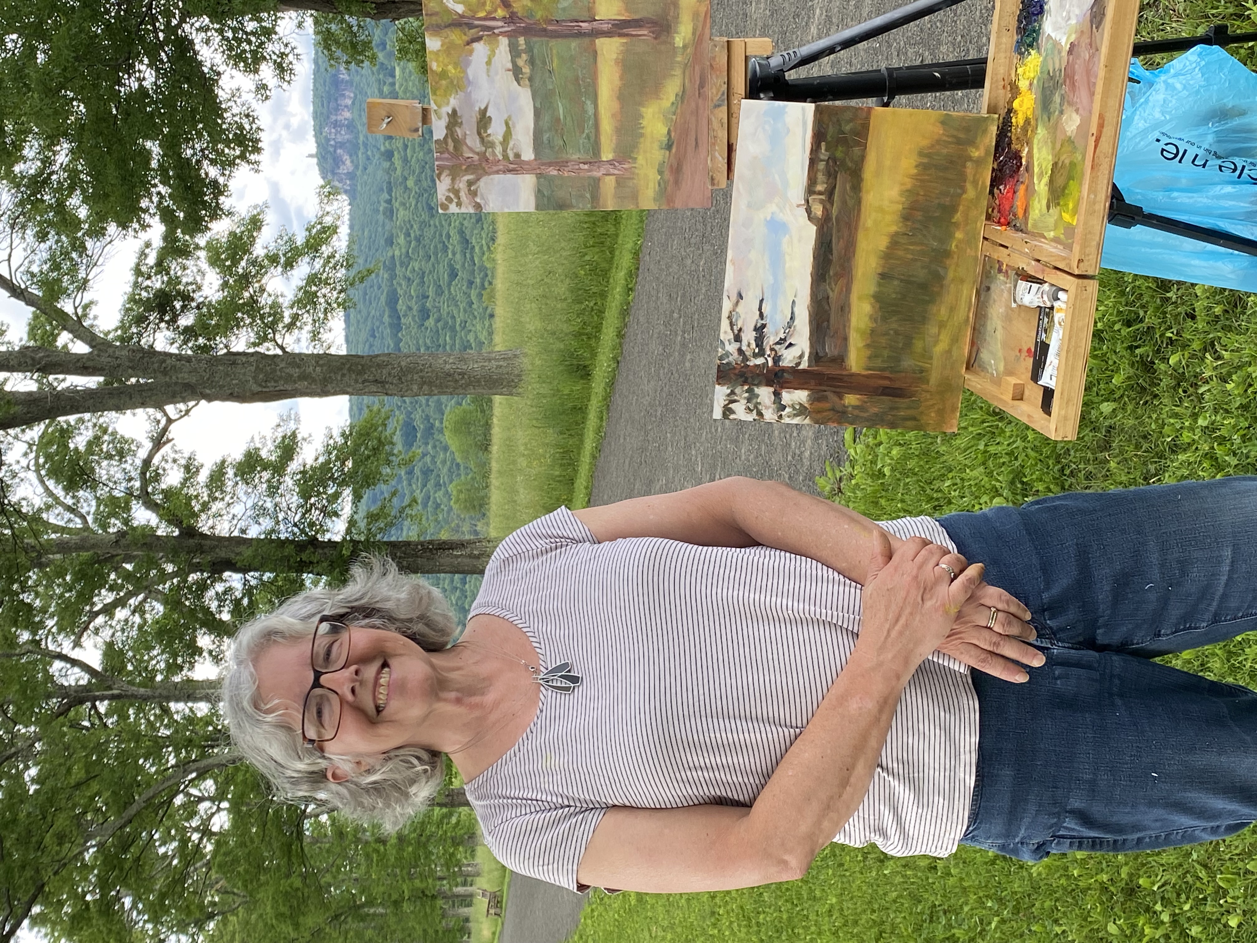 Elisabeth Barnett poses with one of her paintings