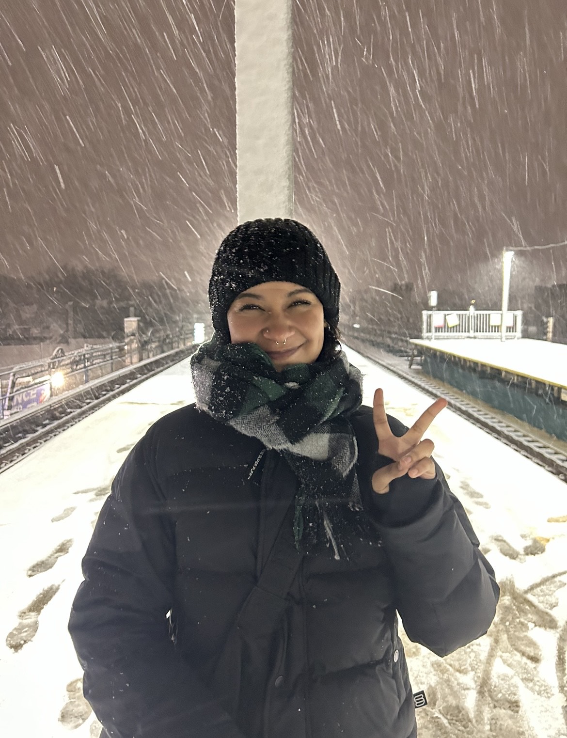 Sarahi Hernandez throwing a peace sign in the snow