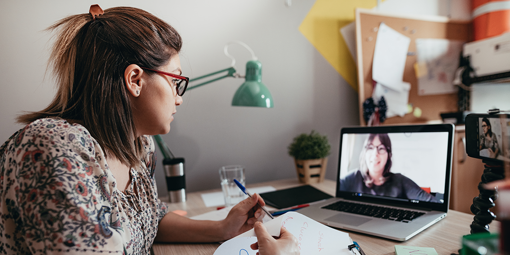 An advisor and student meet via video chat