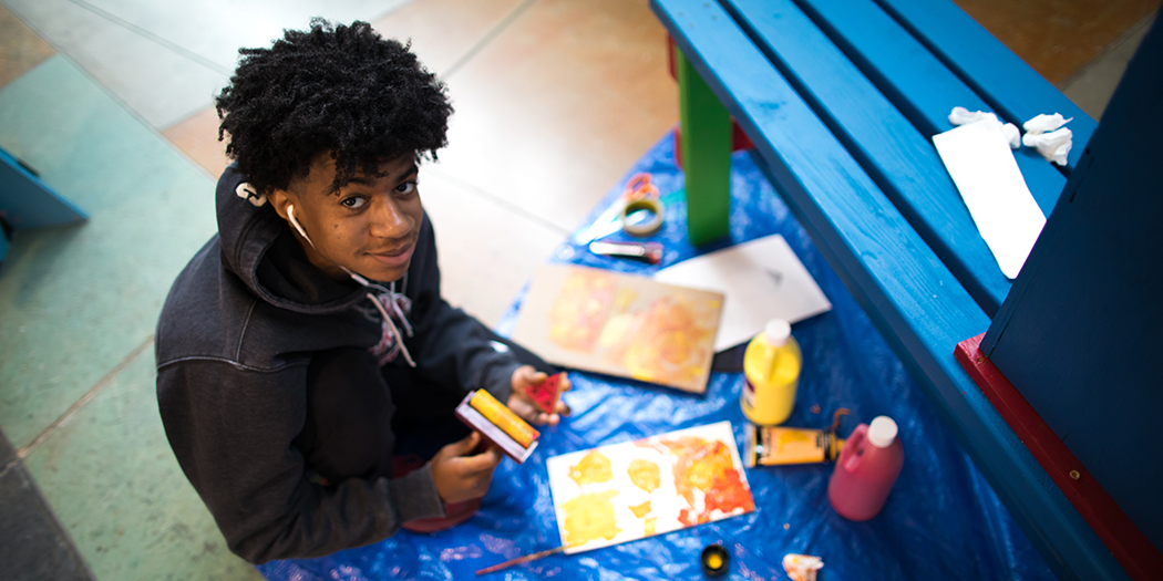 An LCCC student works on a painting