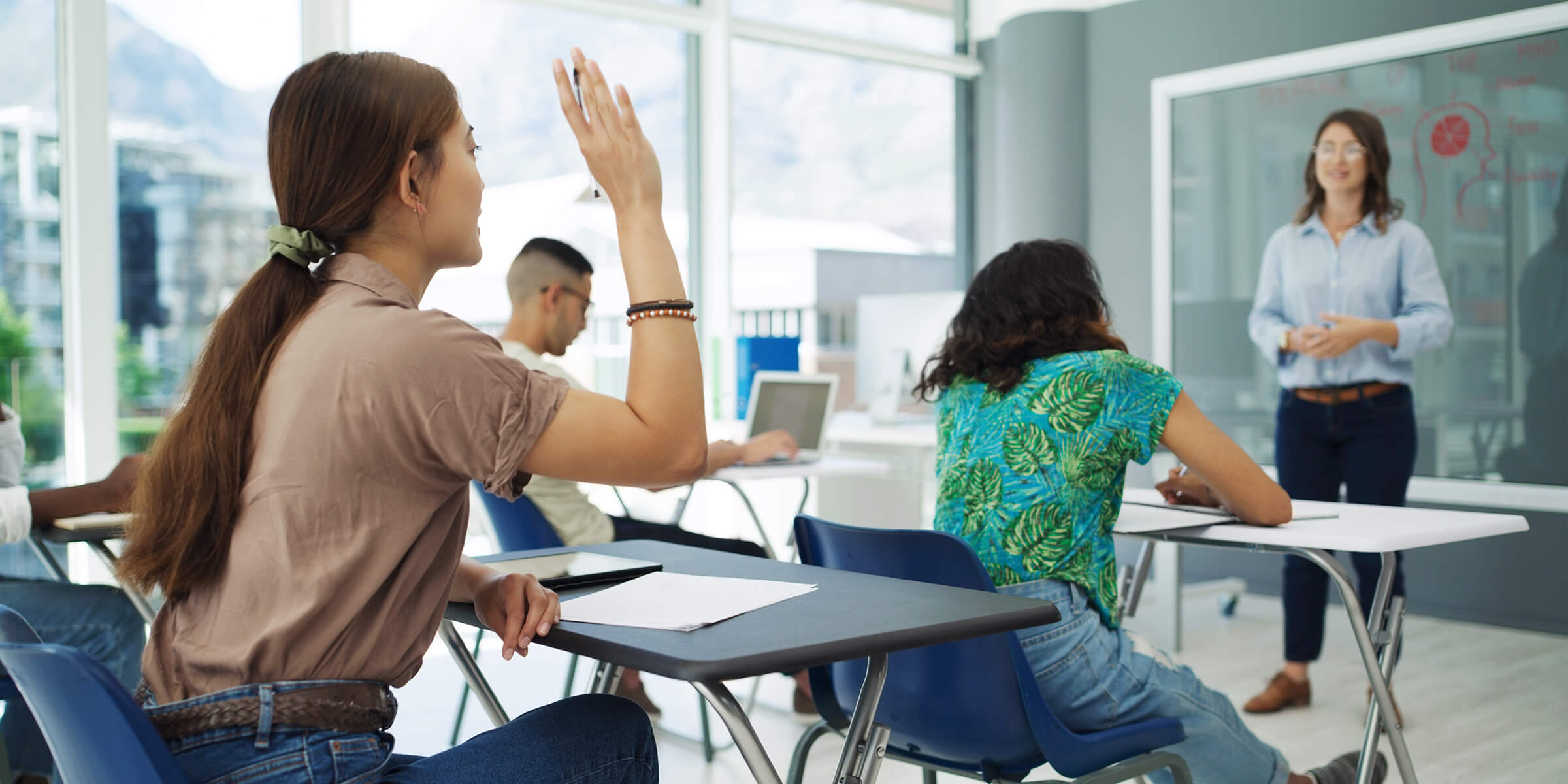 Student raising her hand in class