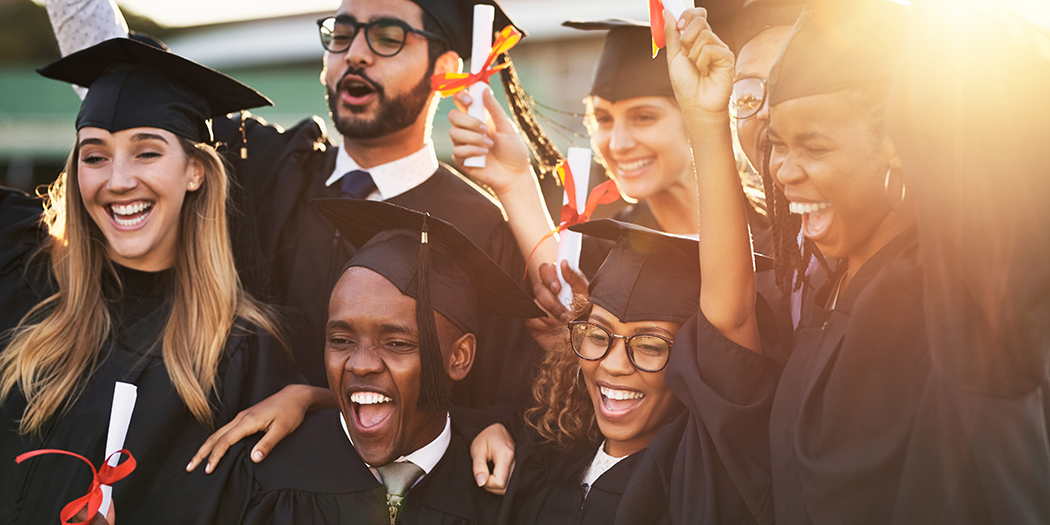 graduates celebrate in caps and gowns