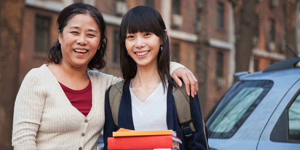 Parent smiling with student