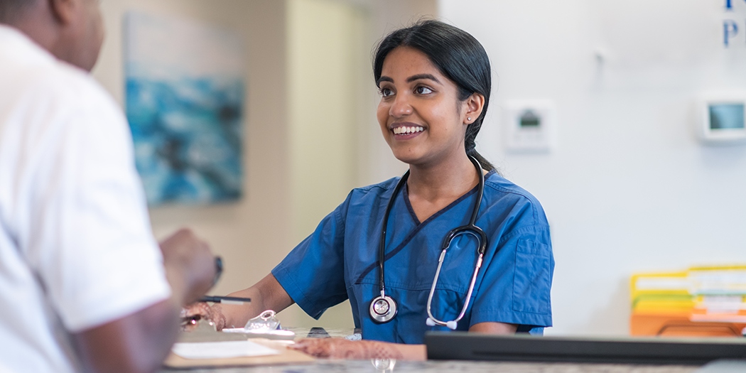 A nurse checks in a patient