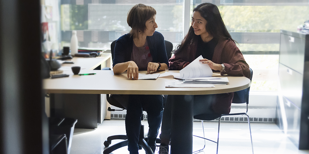 An advisor helps a student