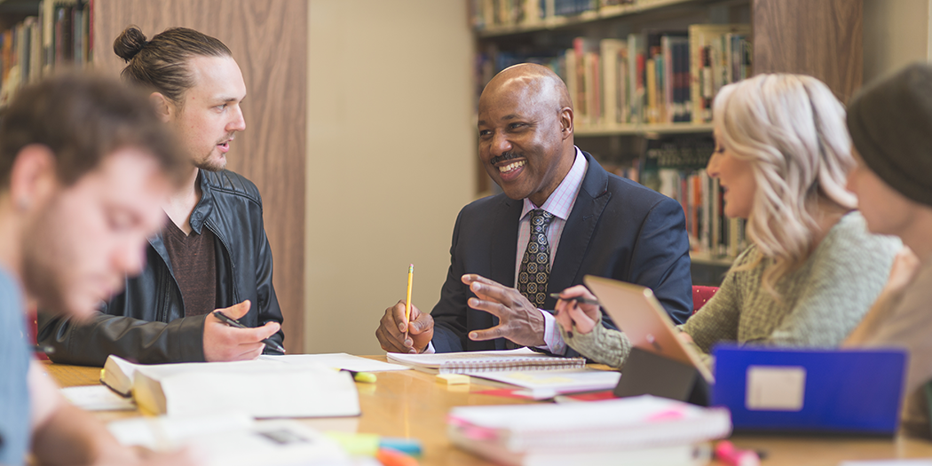 Colleagues work together in the library