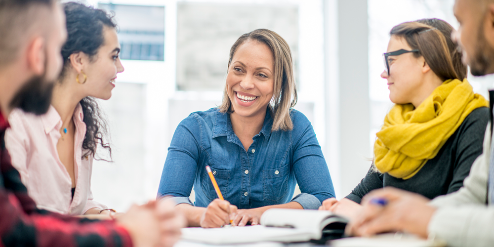 Professionals sit at meeting