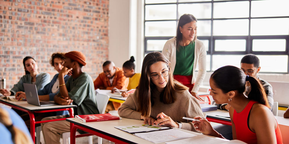 Students seated in a classroom working in groups