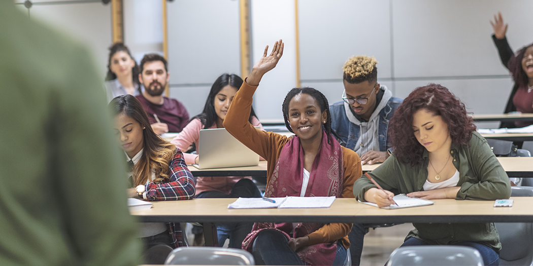 A student raises her hand in class